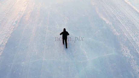 Man Kicking on Frozen Lake in Lulea, Sweden - Winter Landscape Aerial Drone View
