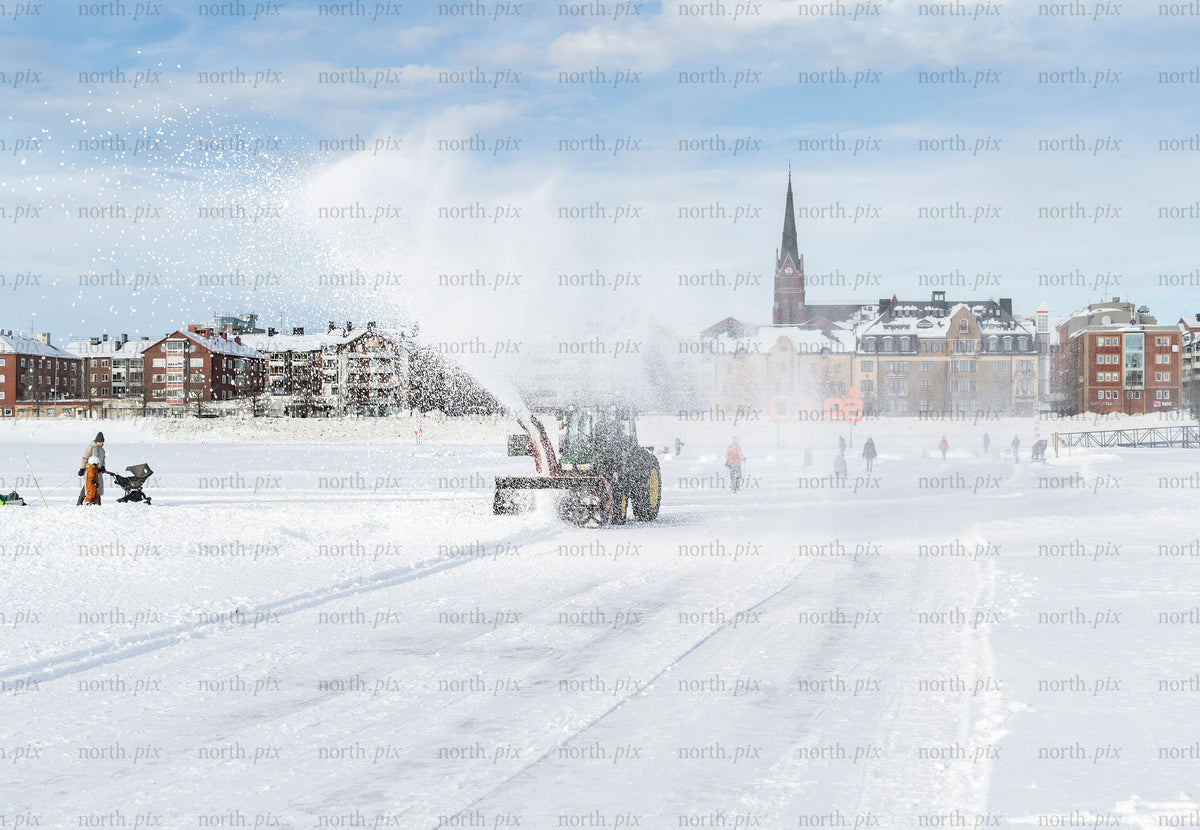 Snowplow clearing ice track on frozen sea, Luleå winter