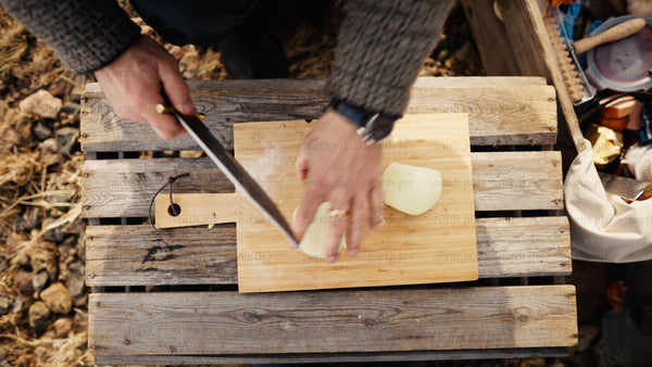 Chopping onions outdoors in the winter sun