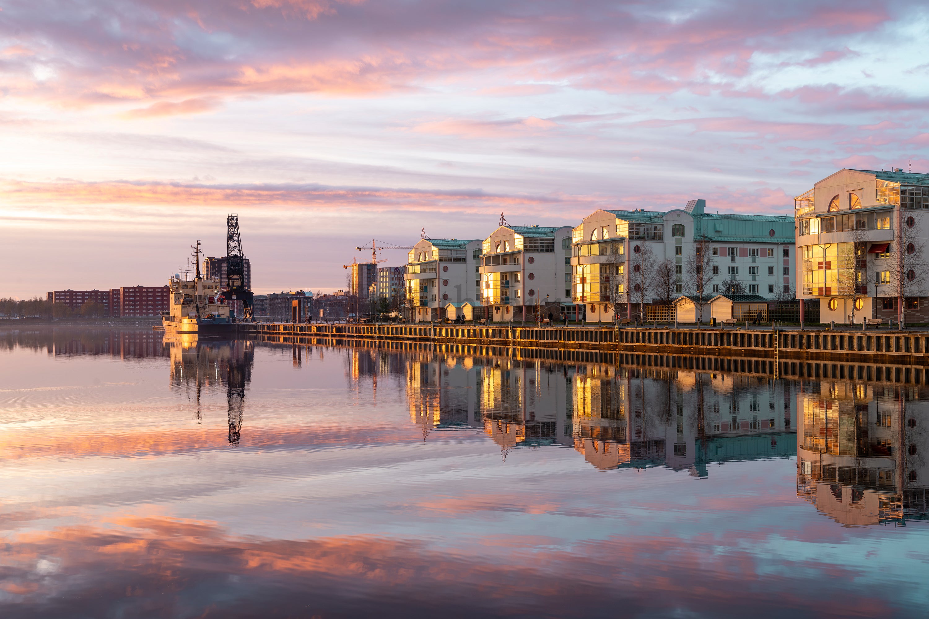 Sunset over Söderhamn waterfront with docked ship
