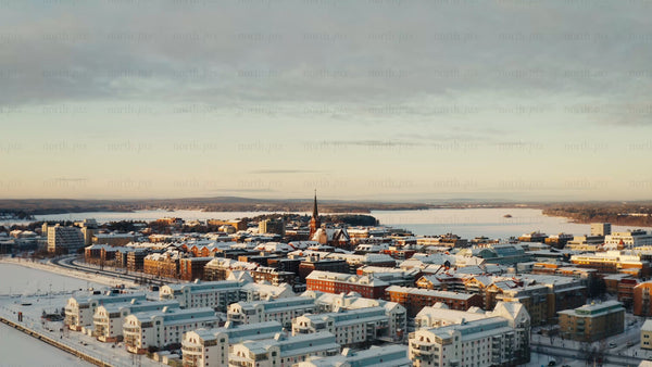 Winter sunrise over Luleå: Aerial drone footage of snow-covered city