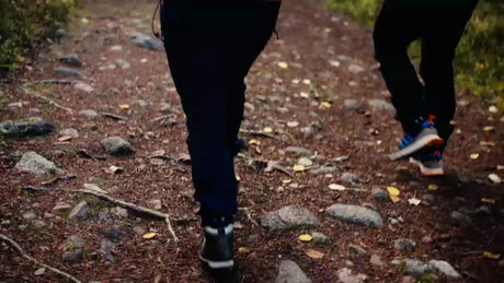 Autumn Hike in Luleå, Sweden: Two People Walking on a Rocky Trail at Bällingeberget