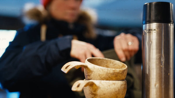 Winter day in Luleå archipelago: Preparing a warm drink in a wooden kuksa