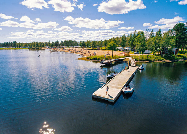 Aerial view of a pier and beach during a bright summer day