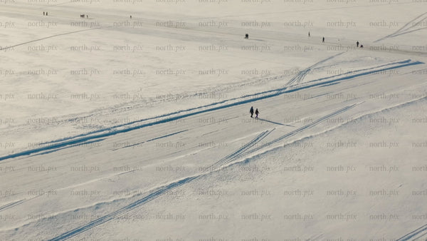 Winter wonderland in Luleå: Aerial drone footage of snowy landscape and frozen lake activities