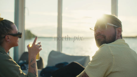 Friends Enjoying a Sunset Boat Trip with Drinks and Conversation in Luleå, Sweden