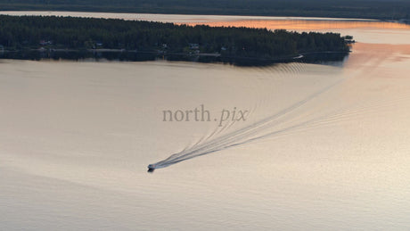 Summer Sunset Boat Ride on a Lake in Lulea, Sweden: An Aerial View of Tranquil Beauty