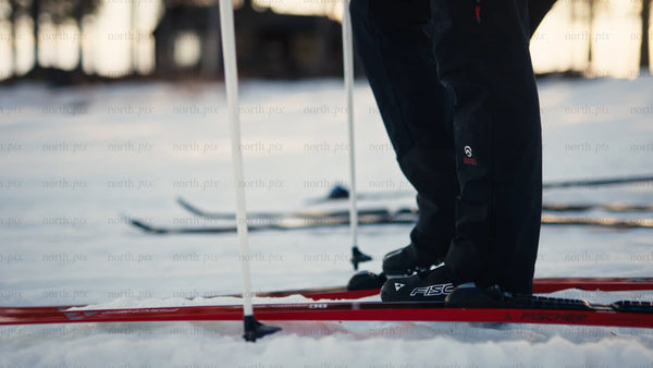 Skiers preparing for cross-country skiing in Luleå at golden hour