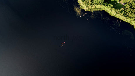 Kayakers on Calm Lake in Luleå, Sweden, Summer Evening Aerial View