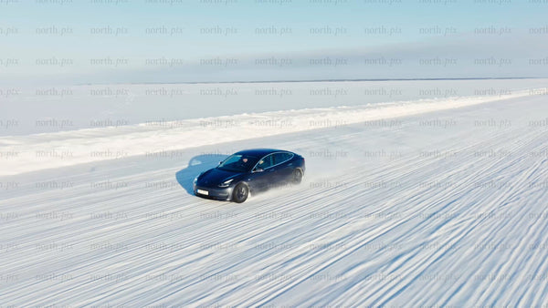 Tesla/car winter driving test on ice road in Luleå - drone footage