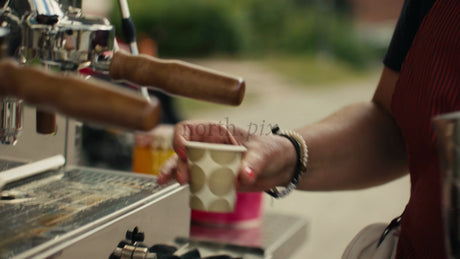 Barista Pours Milk into Coffee at Outdoor Cafe on Summer Day