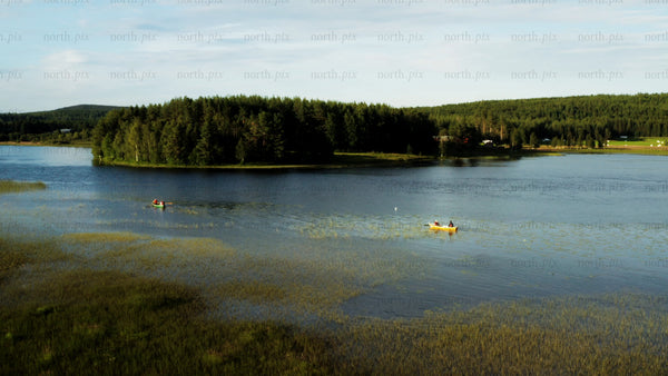 Summer canoeing and kayaking on a lake in Luleå, drone footage
