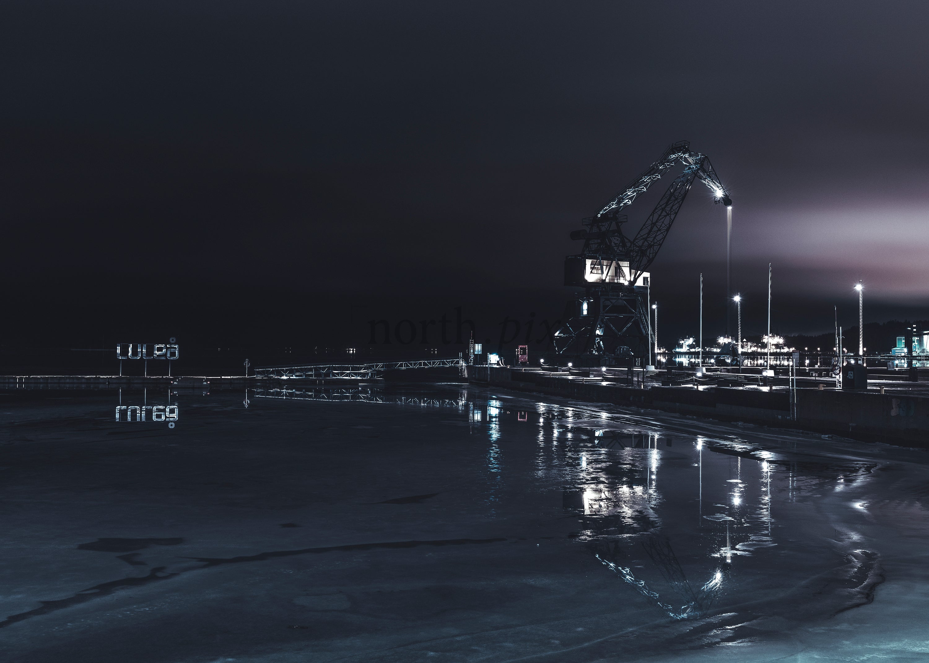 Luleå Industrial harbor crane at night with reflections