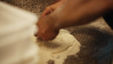 Chef Preparing Pizza Dough: A Close-Up Look at Pizza Making in a Restaurant Kitchen