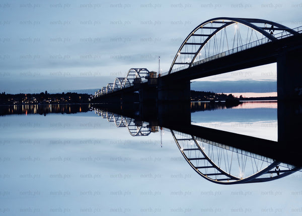 Bridge reflected during blue hour evening over calm waters in Luleå