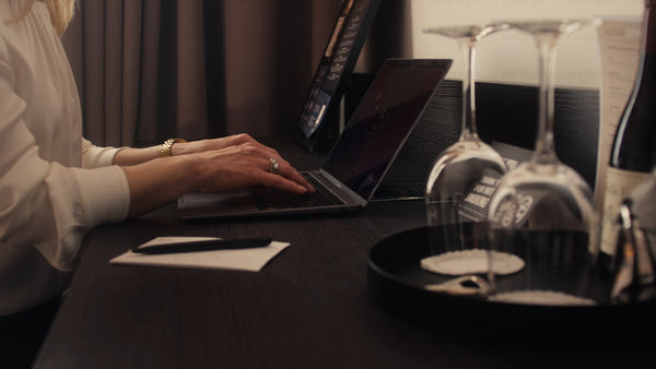 Businesswoman working on her laptop in a modern hotel room