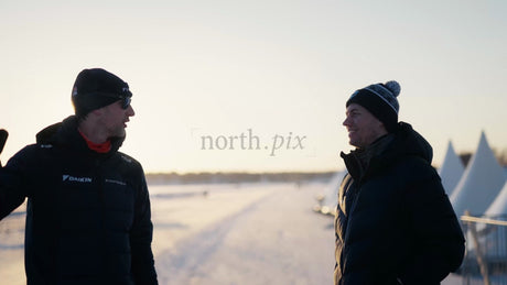 Two Men Talking on a Frozen Lake in Luleå, Sweden During Golden Hour