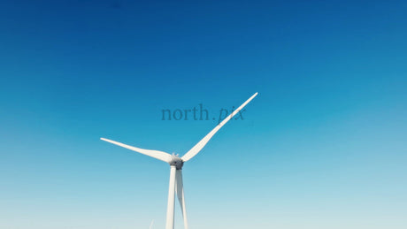 Wind Turbine Spinning in Winter Landscape: Sustainable Energy in Remote Area