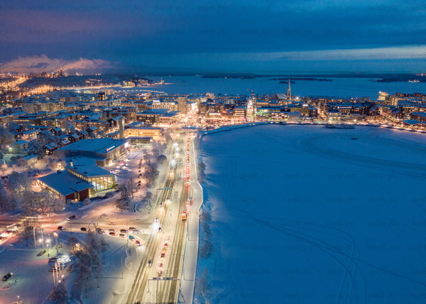 Aerial view of Luleå in winter during the evening with illuminated streets