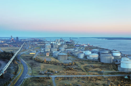 Aerial view of coastal storage tanks at dusk
