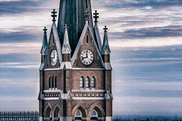 Historic church clock tower against winter sky