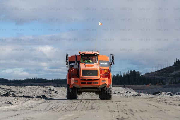 Orange Doosan dump truck on construction site in daytime