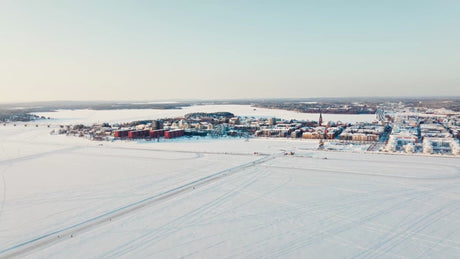 Winter in Luleå: Aerial Drone View of Frozen River and City Center in Sweden
