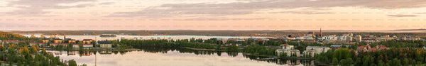 Panoramic aerial view of city skyline by a lake at evening
