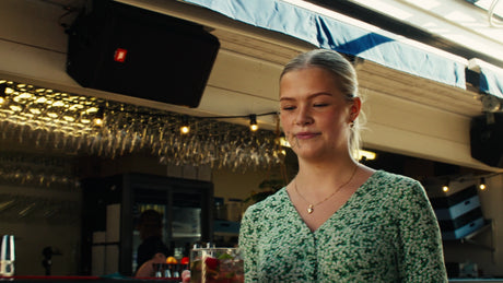 Friends Enjoying Drinks at a Rooftop Bar in Lulea, Sweden on a Sunny Summer Day