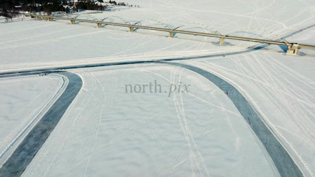 Winter Day in Luleå: Drone View of Frozen River, Bridge, and Ice Skating