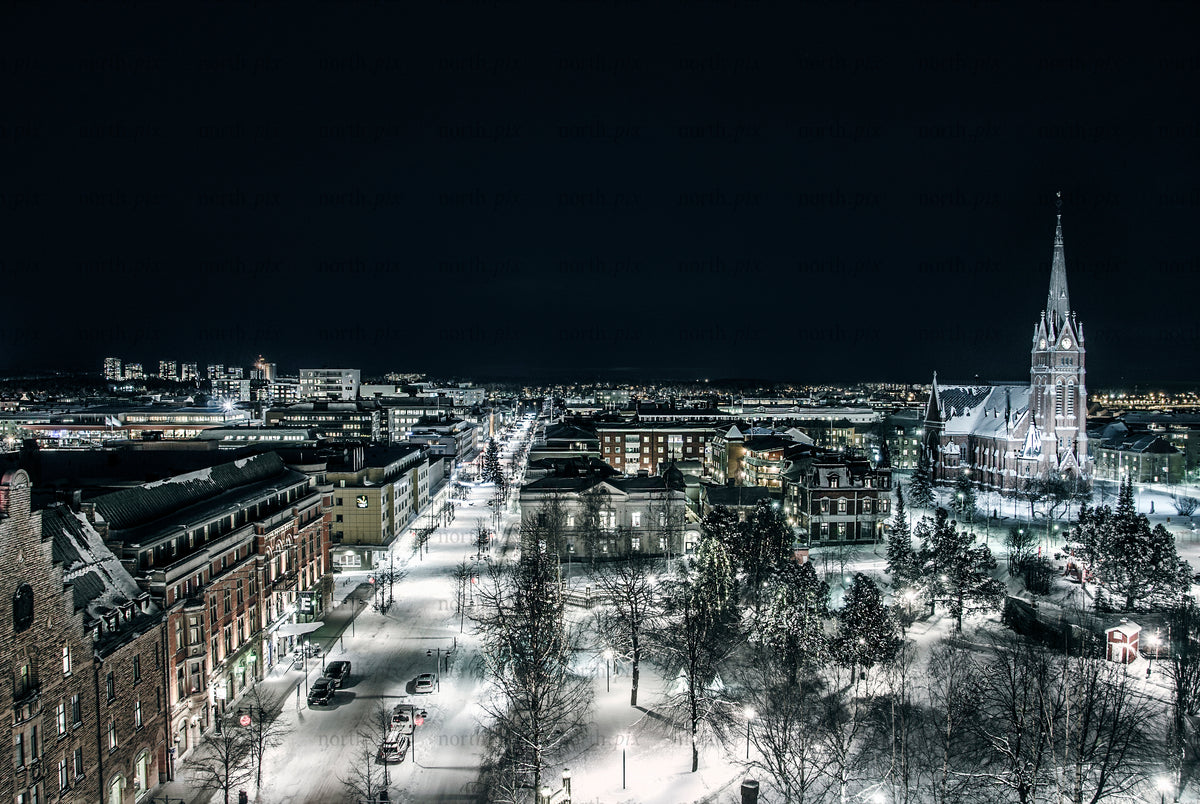 Night aerial view of snowy city with church