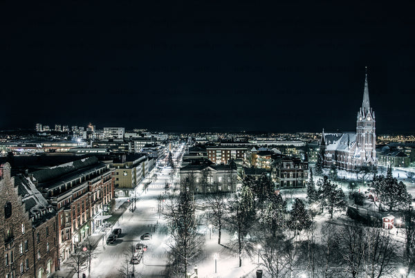 Night aerial view of snowy city with church