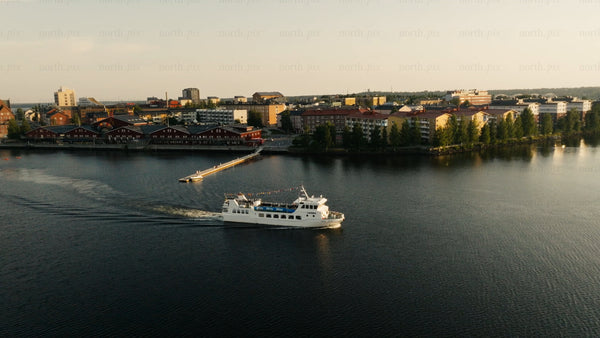 Aerial view of Luleå city center with ferry at sunset during summer