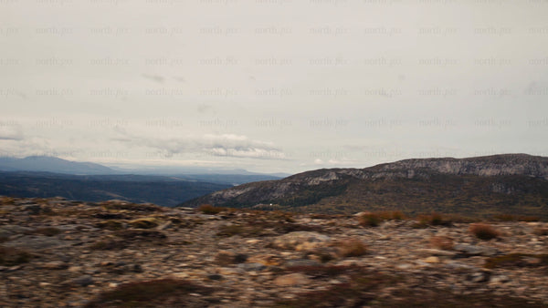 Mountain biker rides downhill on rocky ridge