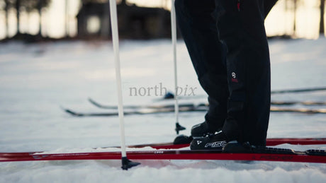 Skiers Preparing for Cross-Country Skiing in Luleå, Sweden at Golden Hour
