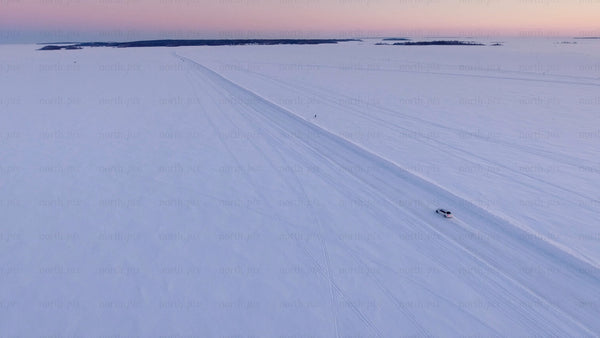Driving on a frozen ice road at sunset in the Luleå archipelago