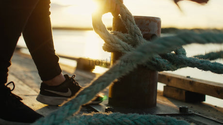 Sunset Over Water, Rope Tied to Mooring on Wooden Dock, Lulea, Sweden