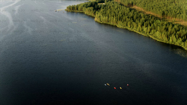 Kayakers on a summer day in Luleå: A drone's eye view of lake and forest