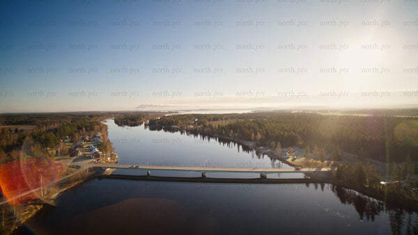 Aerial view of Piteå river and bridge in autumn with reflective waters