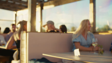 Friends Enjoy Summer Evening Drinks at Rooftop Bar in Lulea, Sweden