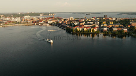 Aerial View of Luleå City on a Summer Evening: Boat Tour, Calm Water, and Sunset Reflection in Sweden