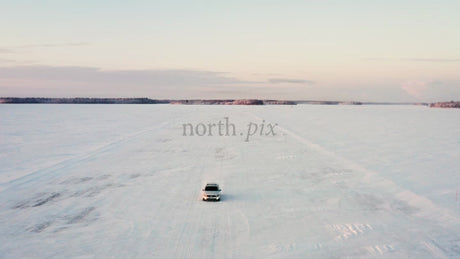 Driving on a Frozen Ice Road in Luleå Archipelago, Sweden, at Winter Sunset