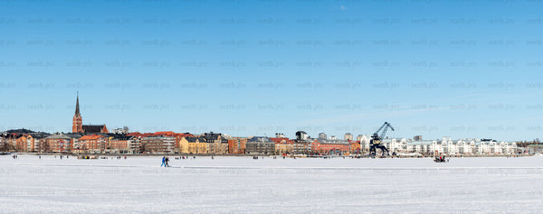 Town skyline with frozen bay in winter daytime