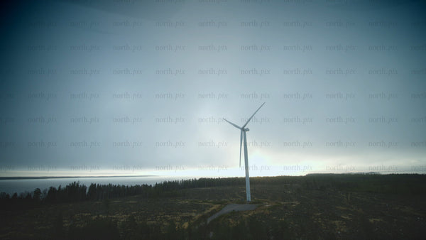 Rotating wind turbine by the sea: Aerial view of sustainable energy in Finland