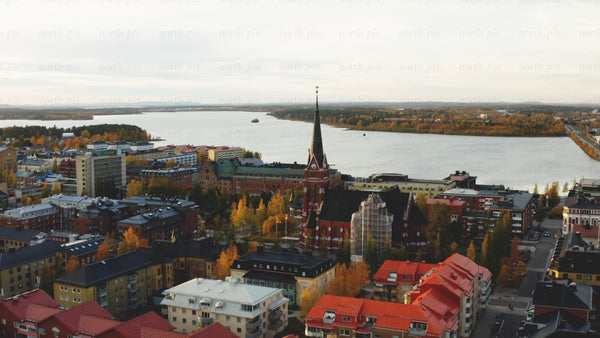Aerial view of Luleå in autumn: Colorful foliage and Luleå cathedral