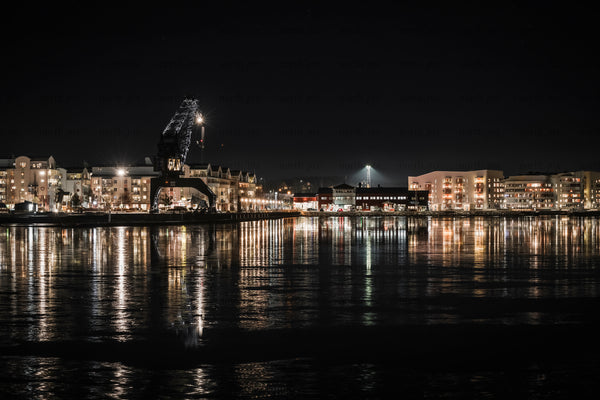 Luleå south harbor waterfront with crane and reflected building Lights