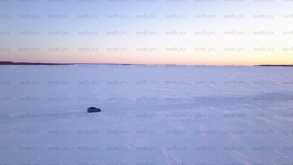 Driving on frozen ice road in lövskär archipelago at sunset
