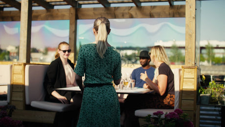 Friends Enjoying Summer Meal at Rooftop Restaurant in Luleå, Sweden