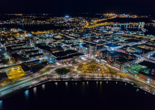 Nighttime aerial view of Luleå cityscape illuminated by urban Lights