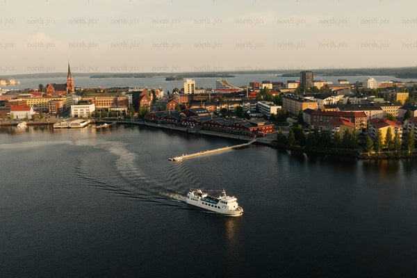 Aerial view of Luleå city center harbor with boat and calm Baltic waters at sunset
